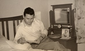 Bruno Ceresoli reading a letter from an unknown correspondent in his bedroom at 230 Palmerston Street, Carlton, a boarding house where he rented accommodation, in 1953