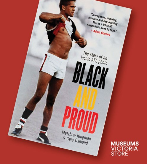 Flat lay image of a book called Black and Proud" on a red background