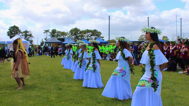 Dancers in traditional costume preforming outdoors