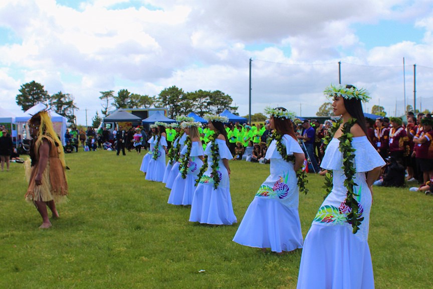 Dancers in traditional costume preforming outdoors