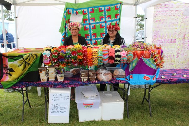 Two women standing behind a table