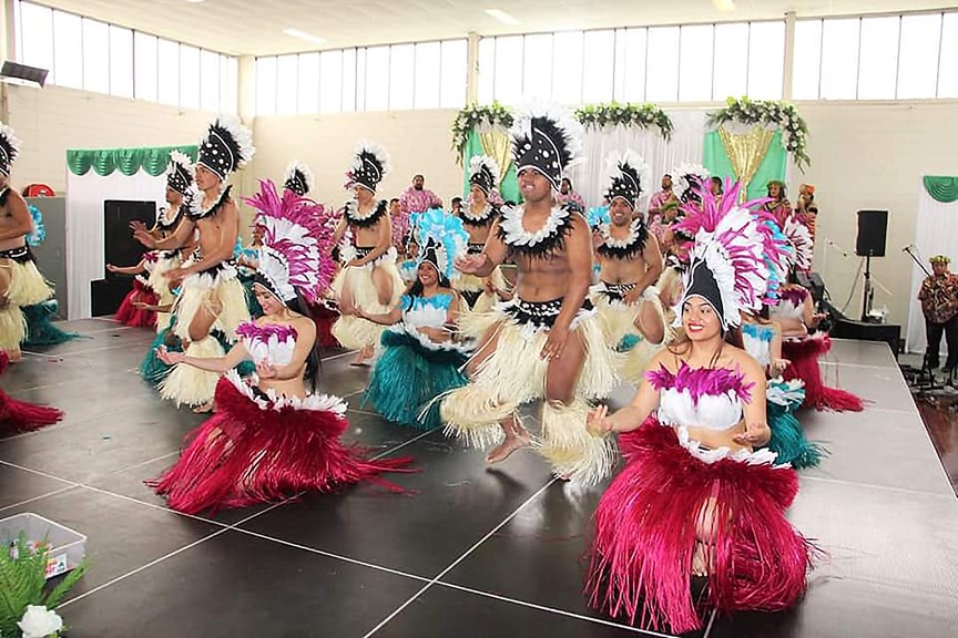 Performers wearing traditional costume on stage