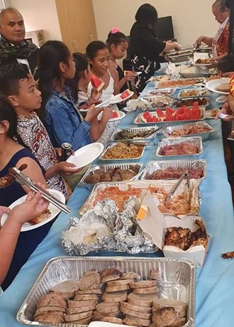 Long table with foil trays of food