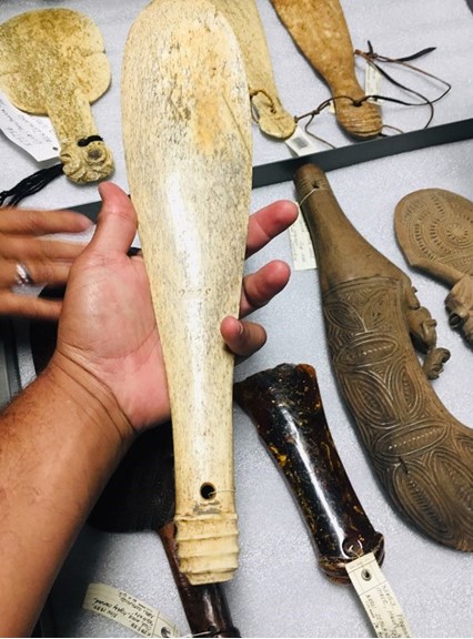 hand holding a tool made from whalebone