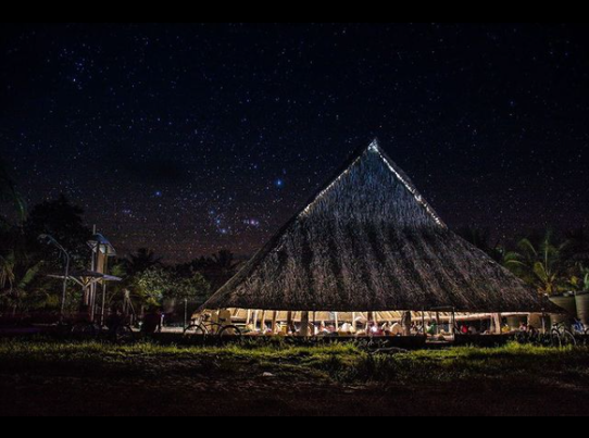 High thatched roof structure without walls at night time