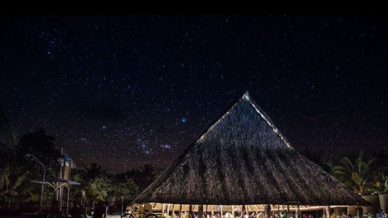 High thatched roof structure without walls at night time