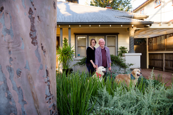 Man, woman and two dogs in a yard