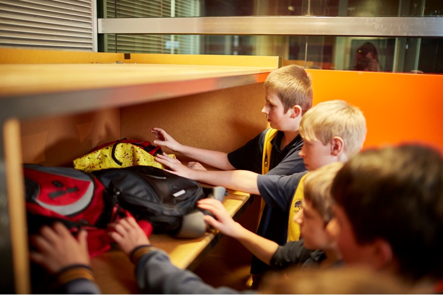 Children leaving their school bags in cubby holes 