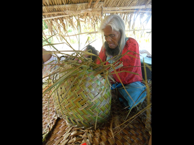 Person weaving with natural fibre