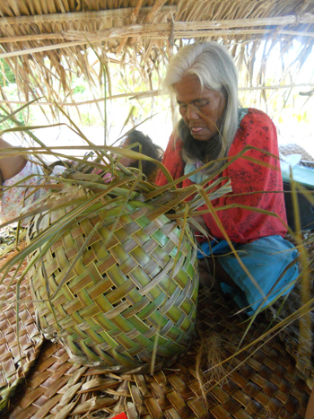 Person weaving with natural fibre