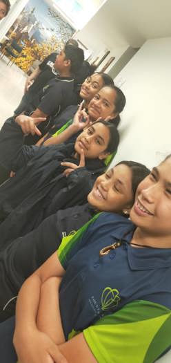 A photograph of a group of secondary school students. The photo has been taken on an angle