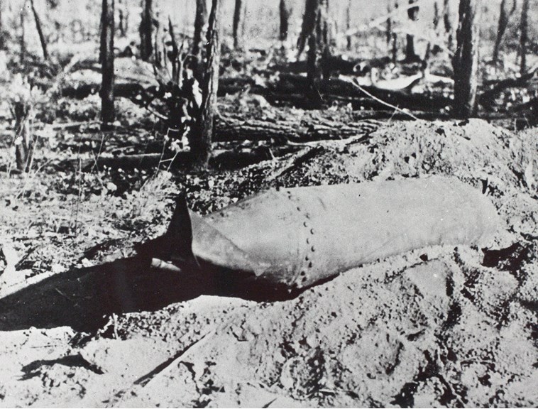 An unexploded Japanese bomb laying in the dirt near Darwin