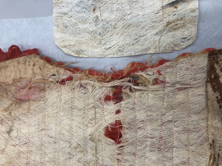 Damaged costume with a cloth repair patch