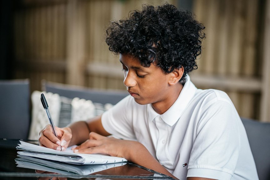 Boy writing in a journal