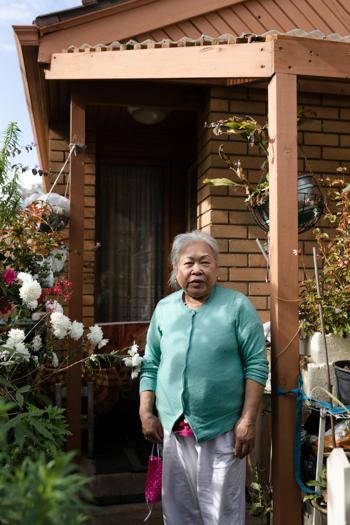 Woman standing in front of a house