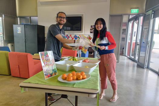 Man and woman sharing fruit