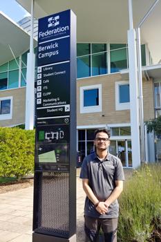 Man next to university sign