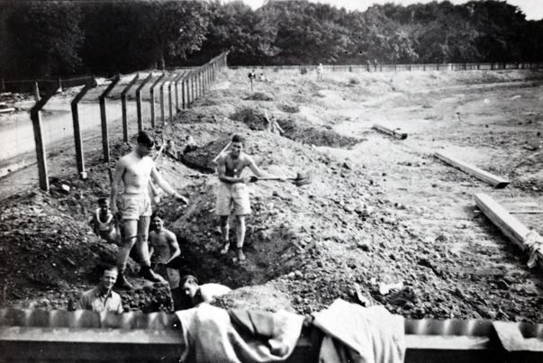 A black and white photo of trench diggers outside Melbourne's Exhibition Buildigs
