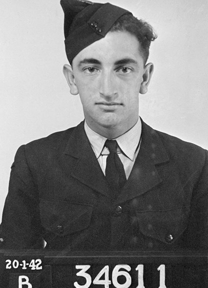 A black and white photograph of a young man in uniform