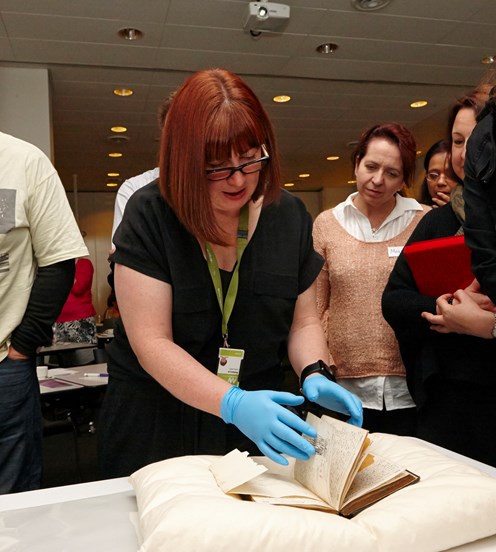 Curator Rebecca Carland presenting rare books at Thinking Without Borders, teacher professional development workshop