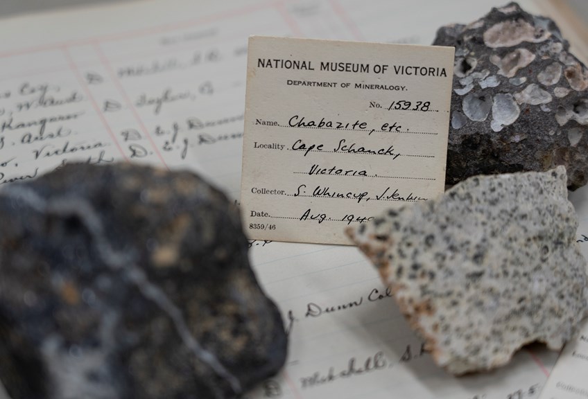 a closeup shot of three rocks with a specimen label