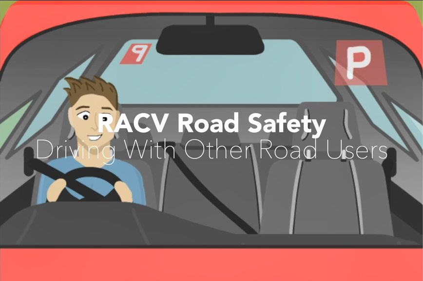 The opening title from the Road Safety Animation. The title is displayed against a cartoon of a boy driving in a red car. Red P-plates are shown.