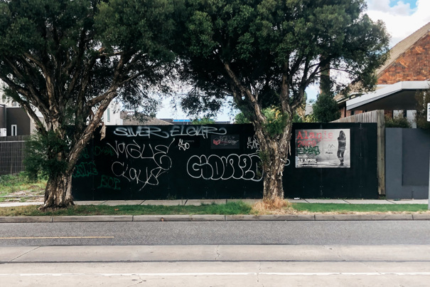 Black fence with graffiti