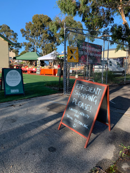 COVID sign outside the farmers market