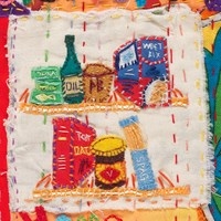 Detail hand embroidered quilt showing a food items in a pantry