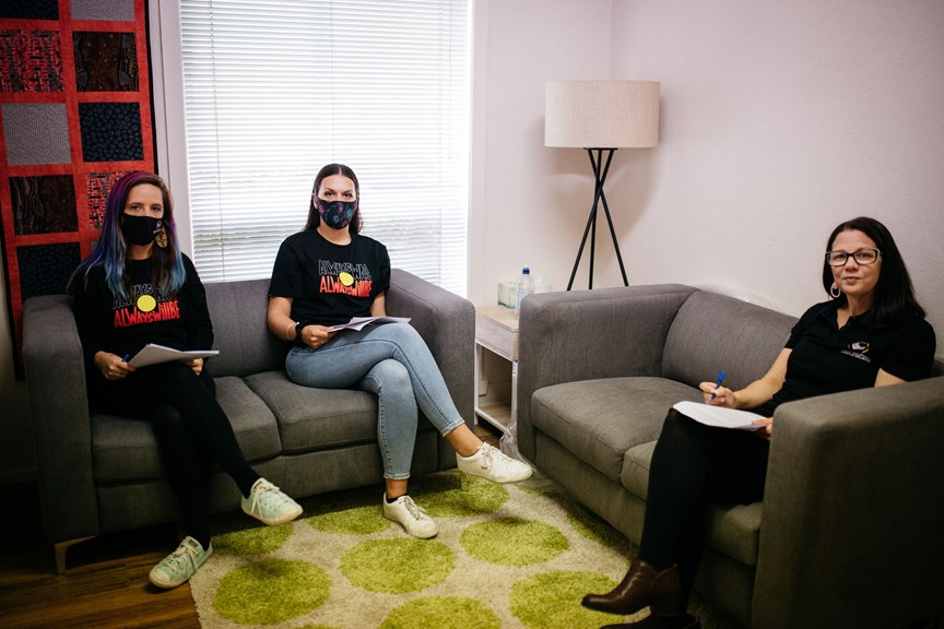 Three woman wear mask and sitting on couches