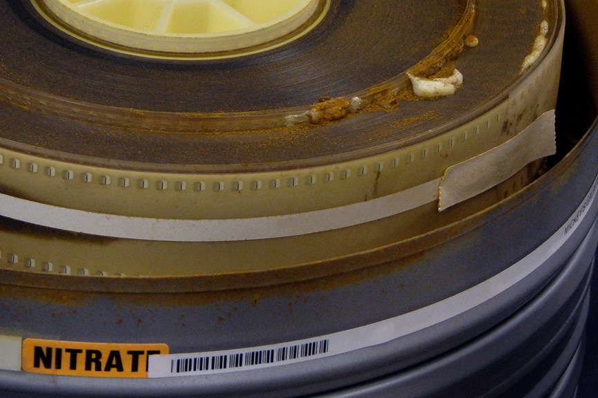 A reel of nitrate film bubbling and turning to dust