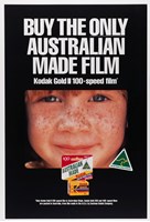 Poster with a black background featuring a close up image of a child's face. White text "Buy the only Australian made film" appears above the image and a box of film below.