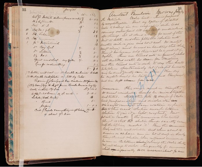 Stained pages of a hard cover notebook with handwritten text
