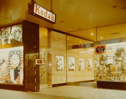 Exterior of a photographic shop. Window displays at store entrance.
