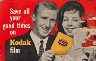 Cardboard poster advertising Kodak super-size prints. The poster, titled 'Save all your good times on Kodak film' has a picture of a man and woman looking at a set of photographs.