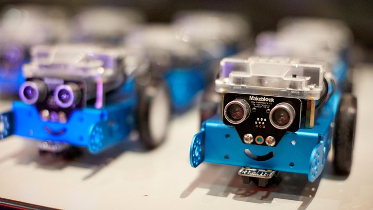 blue robots line-up on a table