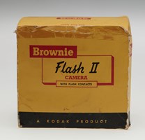 A yellow and black box with red and black text "Brownie Flash II Camera"