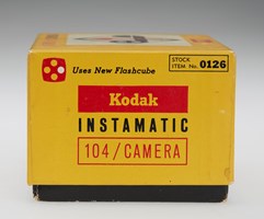 Side view of a yellow camera box. Kodak Instamatic is written on the side in yellow, black and red