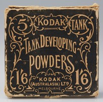 Cardboard box with worn corners. The label is printed in black with the decorative illustration and text shown as the negative