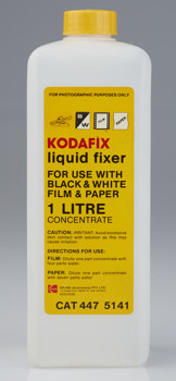 White tall square plastic bottle  with a yellow cap and label