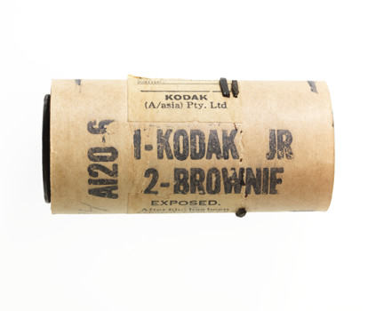 Brown cardboard cylinder with black text printed on it