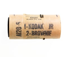 Brown cardboard cylinder with black text printed on it