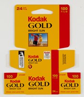 Bundle of 10 un-used, flat pack boxes printed in a yellow, red and black colour scheme with a photograph on the front of a two boys making sandcastles on the beach. 