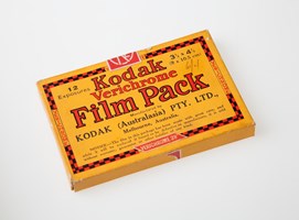 Film pack in cardboard box, printed in red, black and yellow colour scheme.