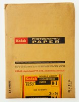 A yellow envelope with black and red text and a sticker of the same colours, printed with product details, seals the envelope.