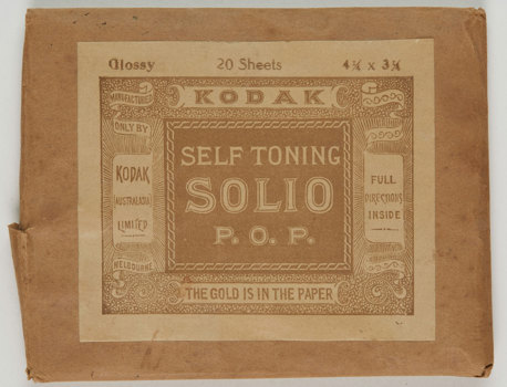 Rectangular brown paper envelope with gold-brown and white sticker label. 