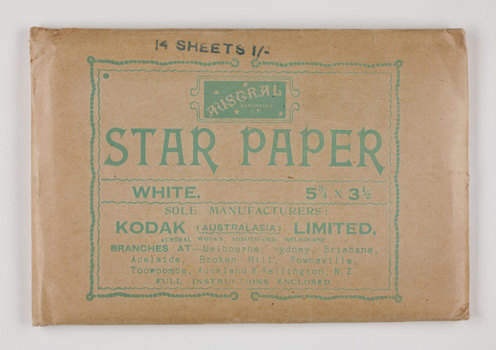 Rectangular brown paper envelope with green printed text.