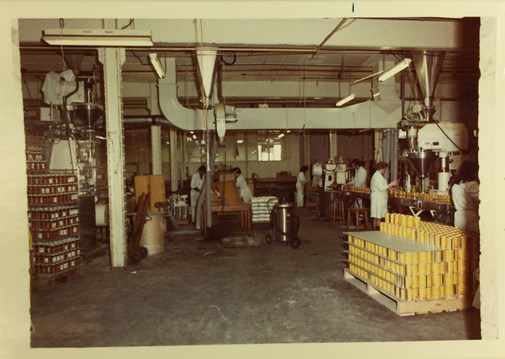 A factory scene with men and woman working on a production line.