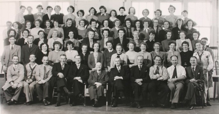 Black and white group photograph feature five rows of men and women