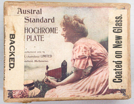 Box with a label  that has black text and image of a woman holding a camera